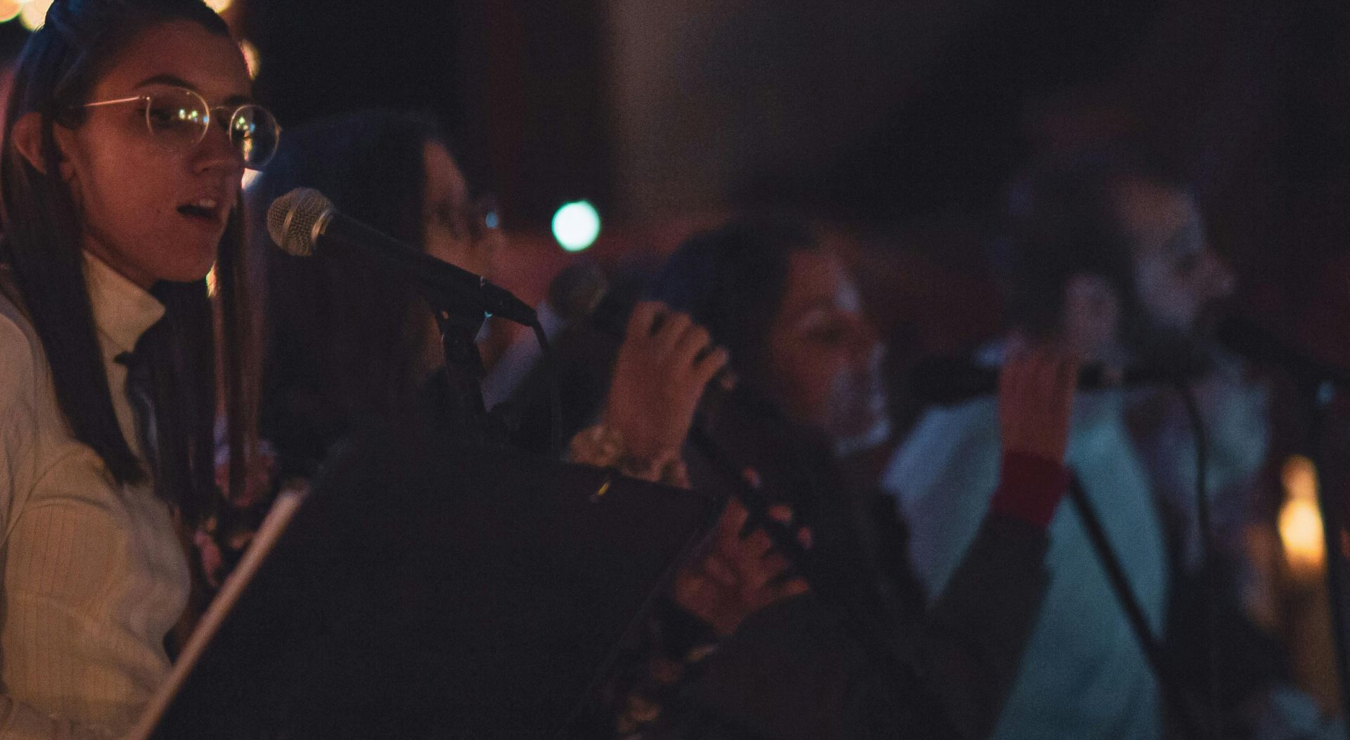 Selective Focus Photo of Women Singing